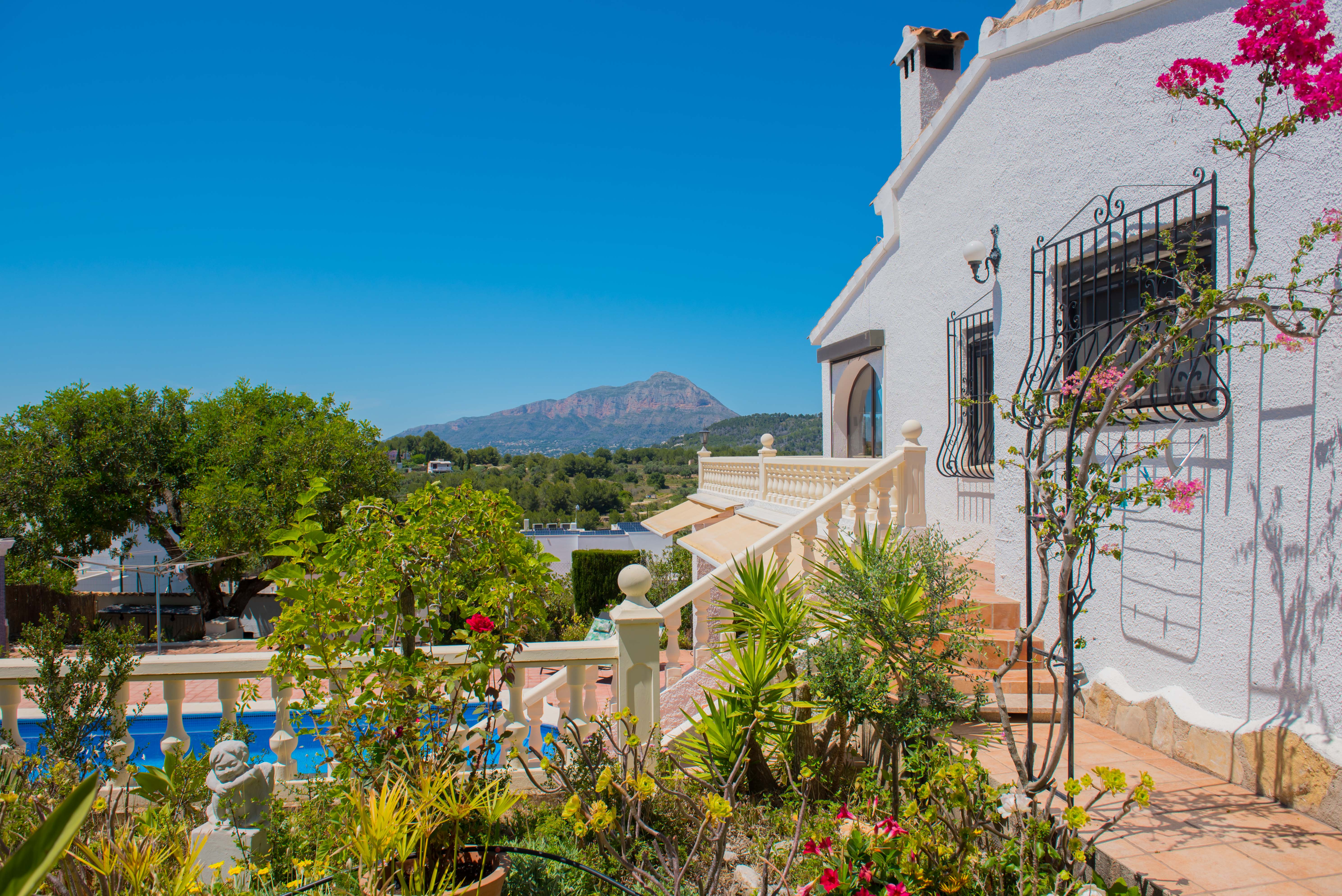 Mediterranean garden with pool and mountain views from the terrace.