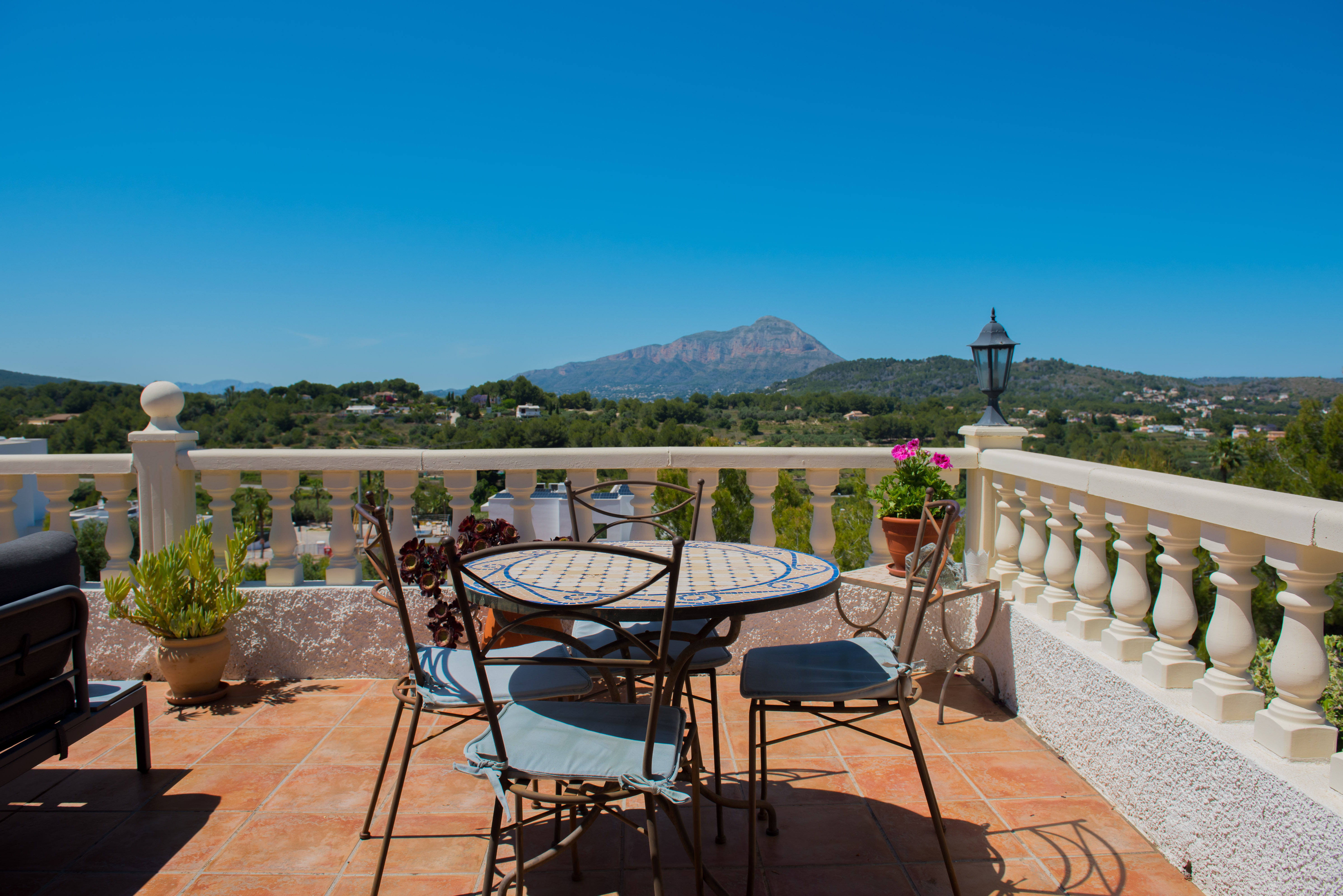 Terrace with mosaic table and mountain views.