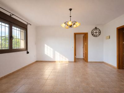Spacious naya with stone arches and a rustic fireplace, offering panoramic views of the valley and majestic Montgó.