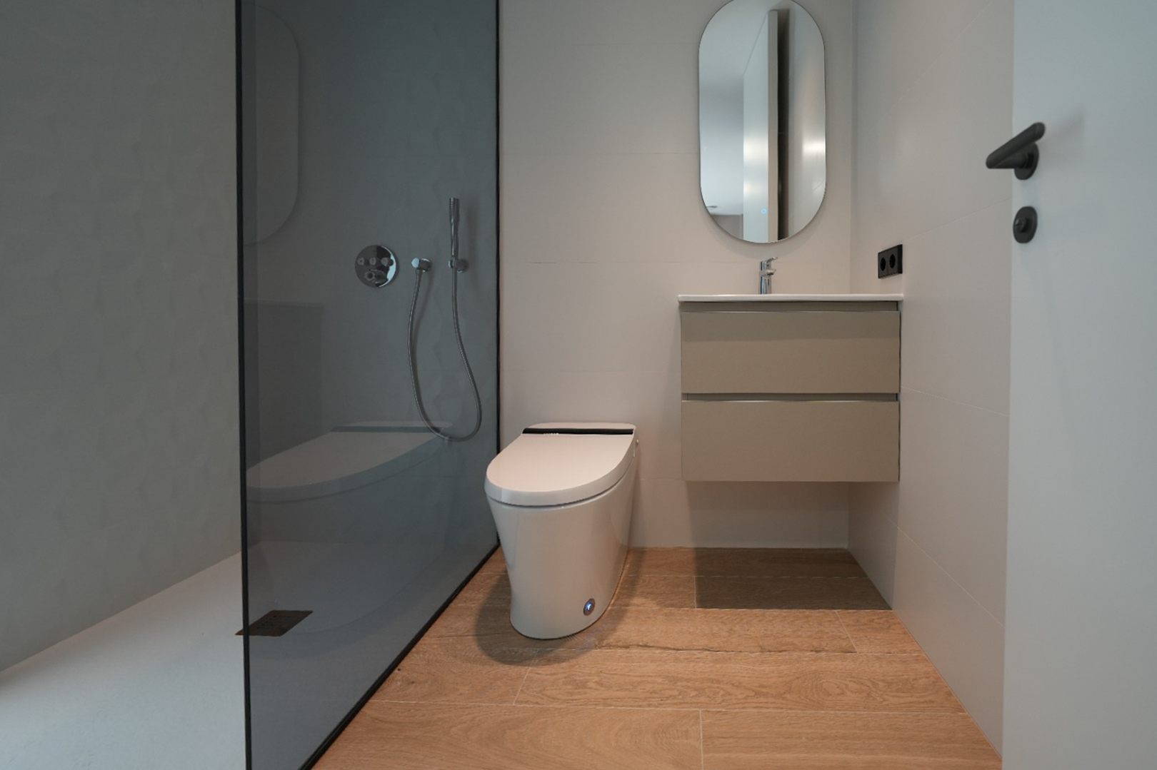 Contemporary bathroom featuring a walk-in shower with dark glass and textured grey wall, a sleek wall-mounted toilet, floating vanity, and light wood-effect floor tiles.