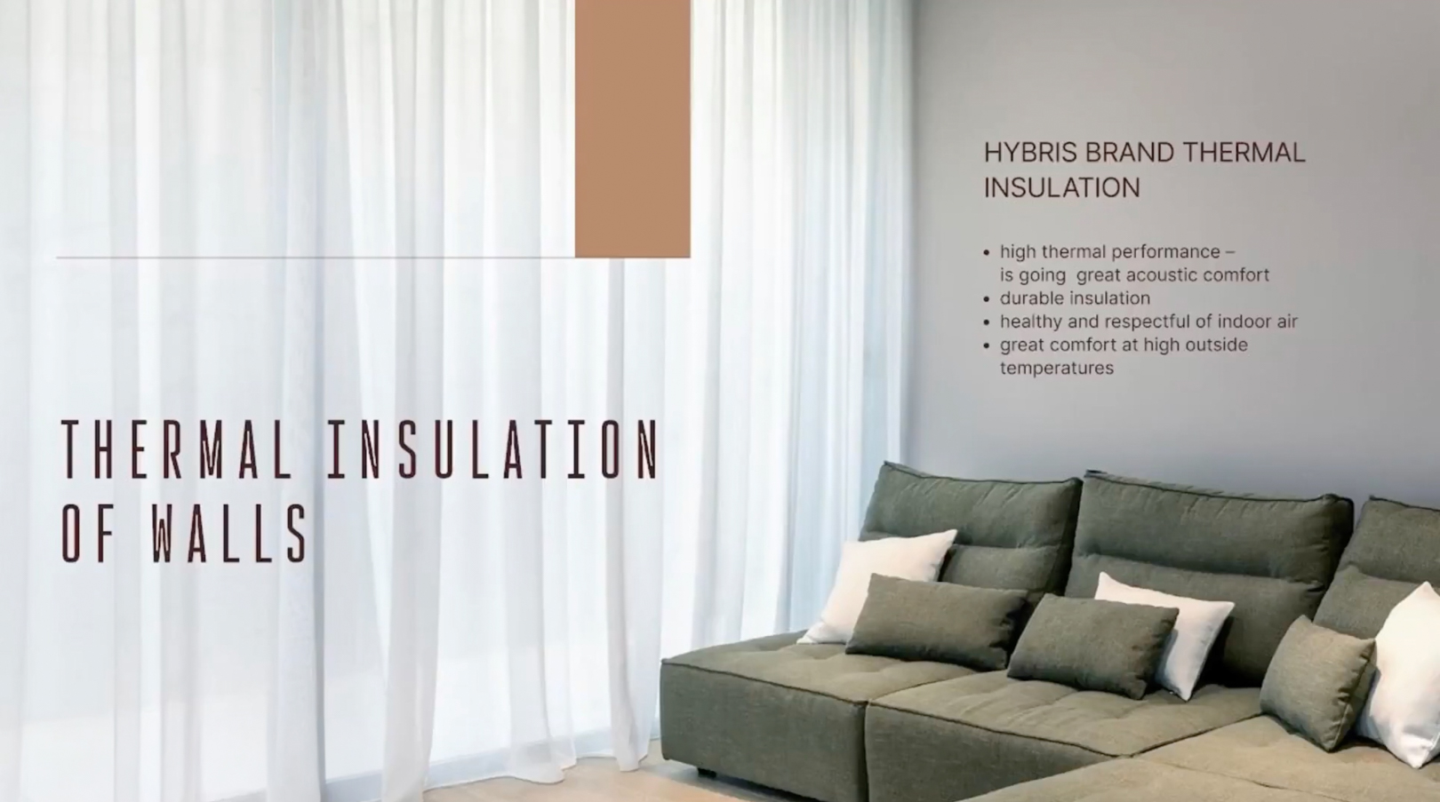 Interior detail illustrating advanced wall thermal insulation, featuring a contemporary corner sofa and elegant sheer curtains.
