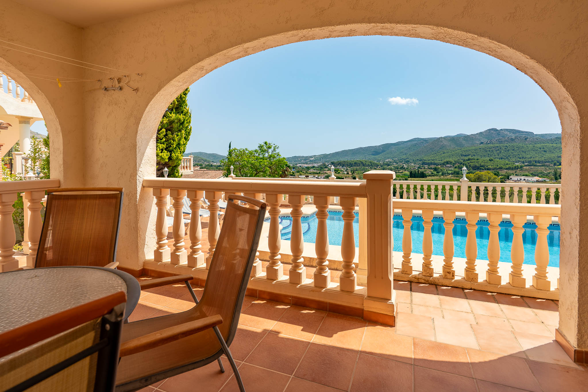Covered terrace with pool views