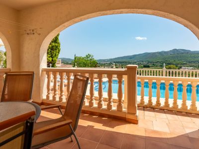 Covered terrace with pool views