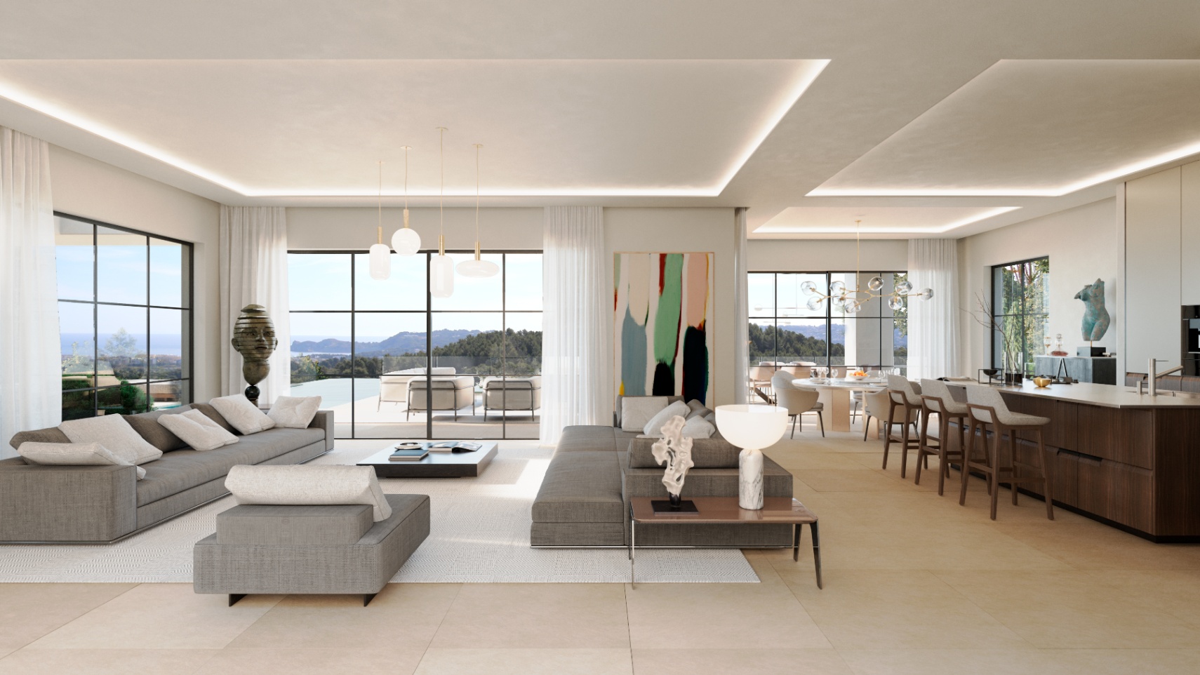 Open-plan living area featuring grey sectional sofas, a dark wood kitchen island, and floor-to-ceiling windows with expansive sea and landscape views.
