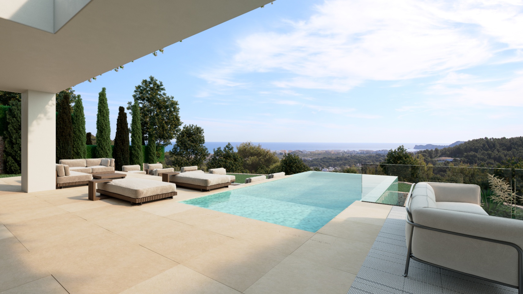 Terrace featuring a stone-tiled deck, infinity pool with glass balustrade, and lounge seating overlooking the Mediterranean coast and forested hills.