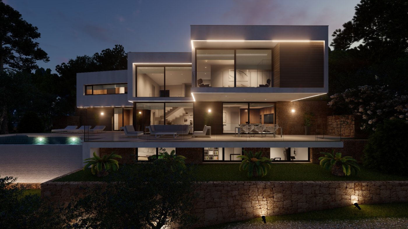 Modern multi-level villa at dusk featuring integrated LED lighting, expansive glass facades, a stone-walled terrace with lounge seating, and a lower-level garden.