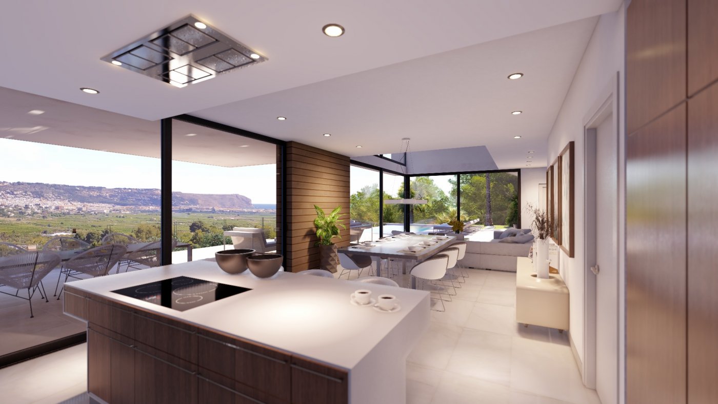 Open-plan living area featuring a kitchen island with induction hob, dining space, and floor-to-ceiling glass doors showcasing panoramic valley and sea views.