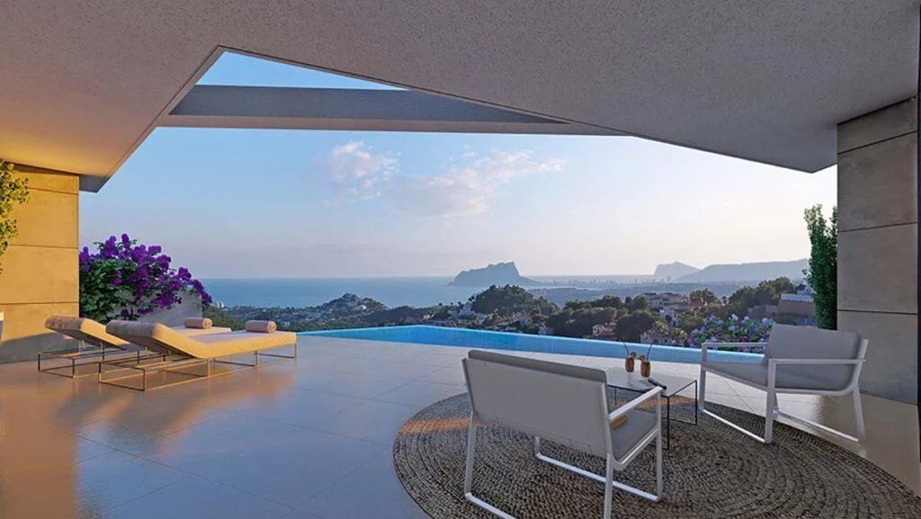 Covered terrace featuring an infinity pool and panoramic views of the Mediterranean Sea and Peñón de Ifach. Includes lounge chairs and a seating area on stone tiling.