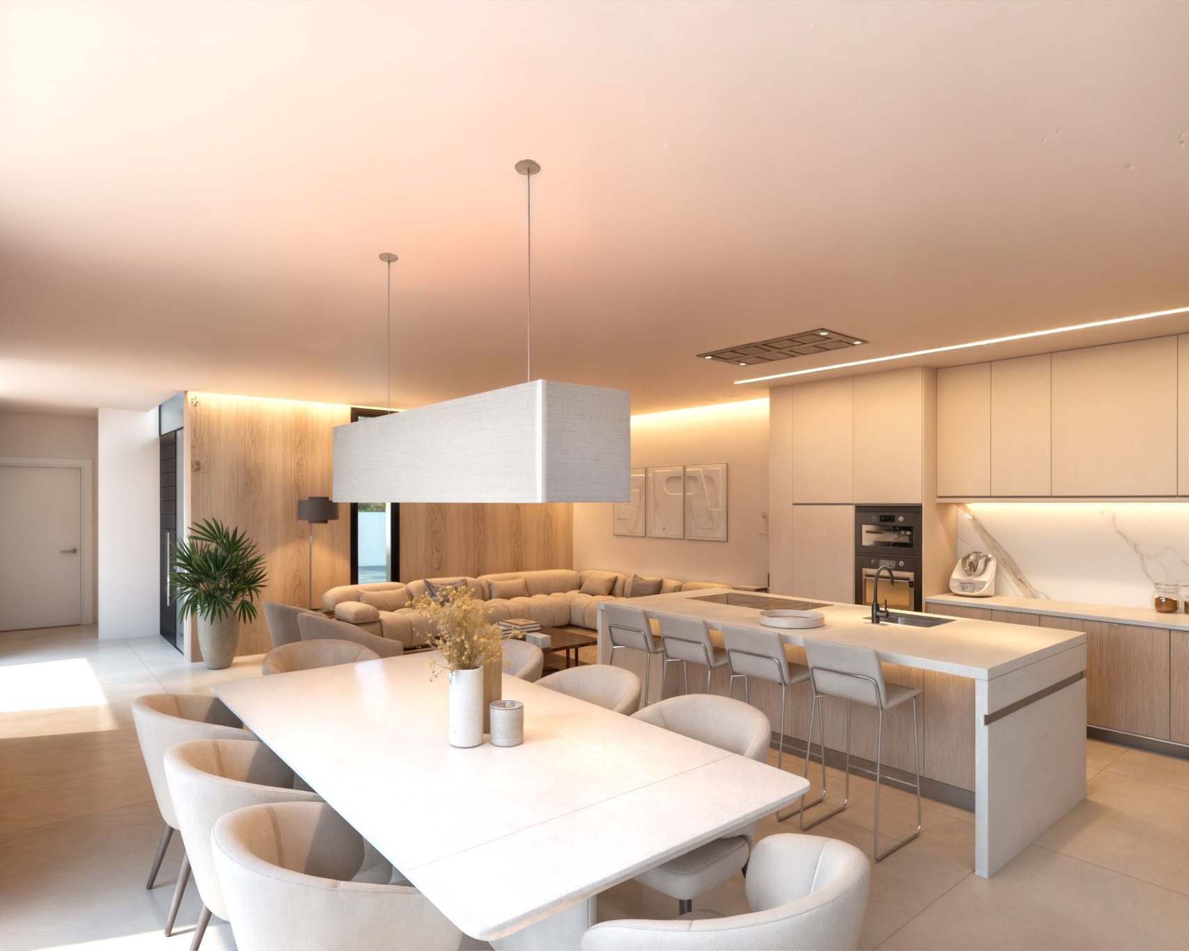 Open-plan living area featuring a kitchen island with stone waterfall edges, integrated appliances, and a dining zone with a large fabric pendant and wood-paneled walls.