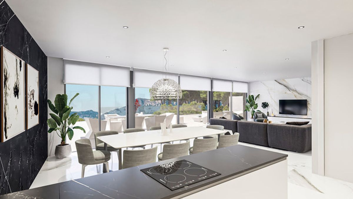 Open-plan living area featuring a white dining table, a dark kitchen island with induction hob, and a lounge with marble-effect walls and floor-to-ceiling windows.