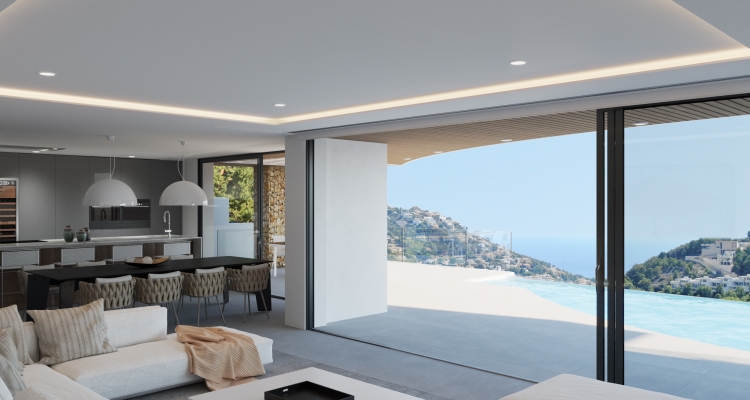 Open-plan living area with floor-to-ceiling glass doors opening to an infinity pool and panoramic views of the Jávea coastline and Mediterranean Sea.