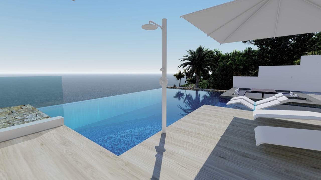 View of the infinity pool with shower and white sun loungers overlooking the sea.