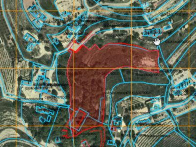 Aerial view of the outlined land, showcasing its expanse and relative location to nearby buildings.