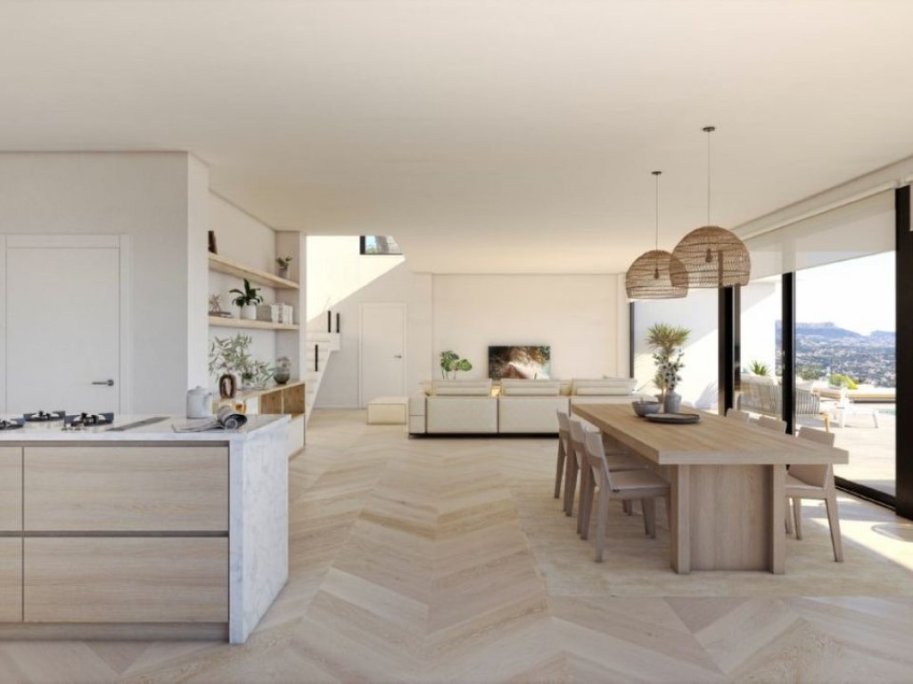 Open-plan living area featuring light wood chevron flooring, a marble-clad kitchen island, and floor-to-ceiling windows overlooking the landscape.