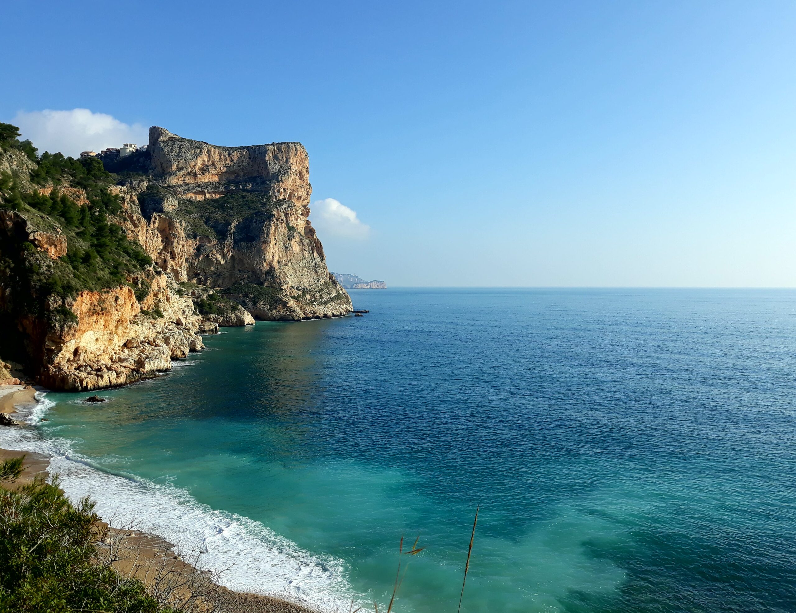 Panoramic views of the rugged limestone cliffs and turquoise Mediterranean waters surrounding the Cumbre del Sol area.