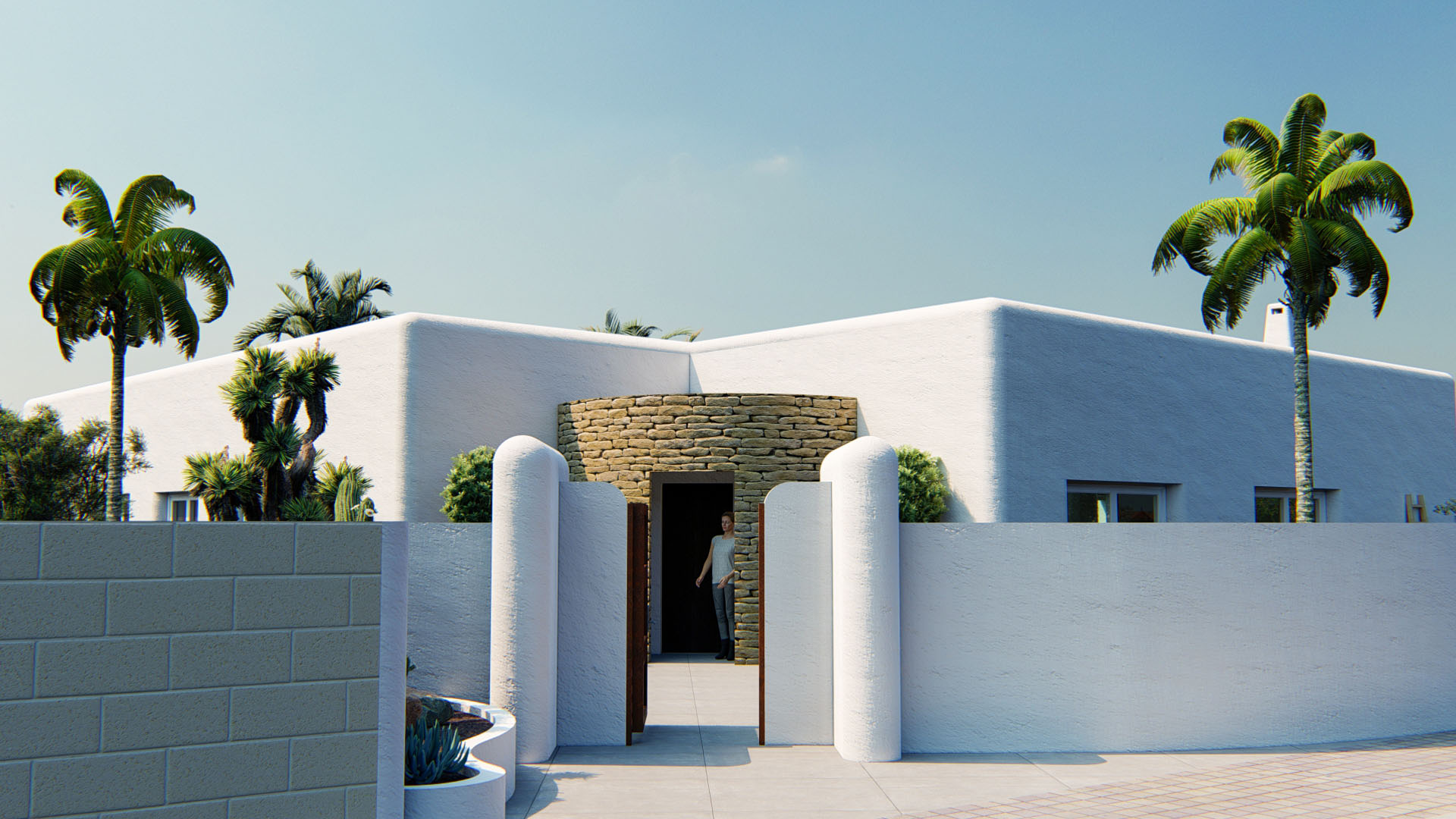 Ibizan-style exterior facade featuring rounded white walls and a main entrance framed by a curved natural stone wall.