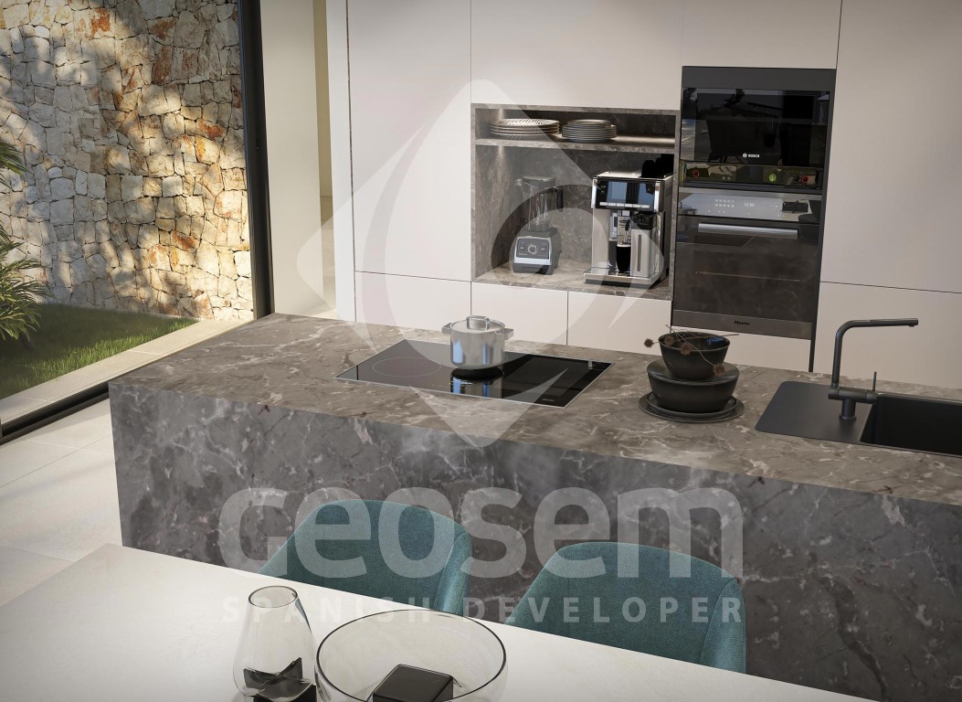 Designer kitchen featuring a grey veined stone island with integrated induction hob and high-end built-in appliances set within minimalist white cabinetry.