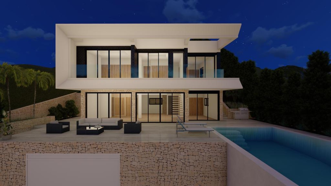 Illuminated rear facade featuring an infinity pool, dry stone walls, and expansive glass doors connecting the outdoor lounge to the modern wood-accented interior.
