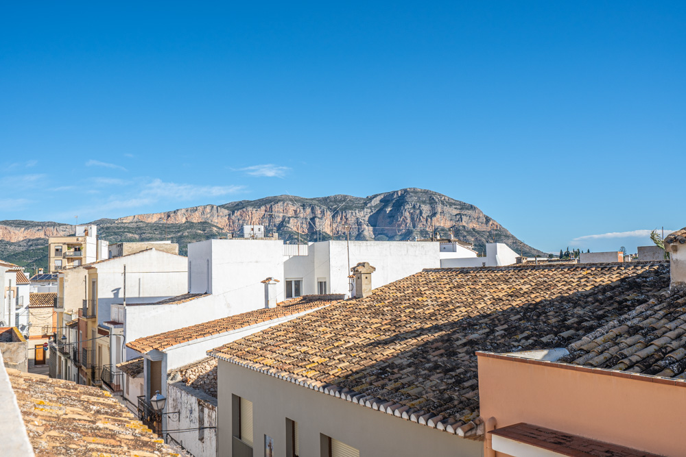 Panoramic views from the rooftop terrace overlooking the Montgó mountain and the traditional terracotta tiled roofs of Gata de Gorgos.