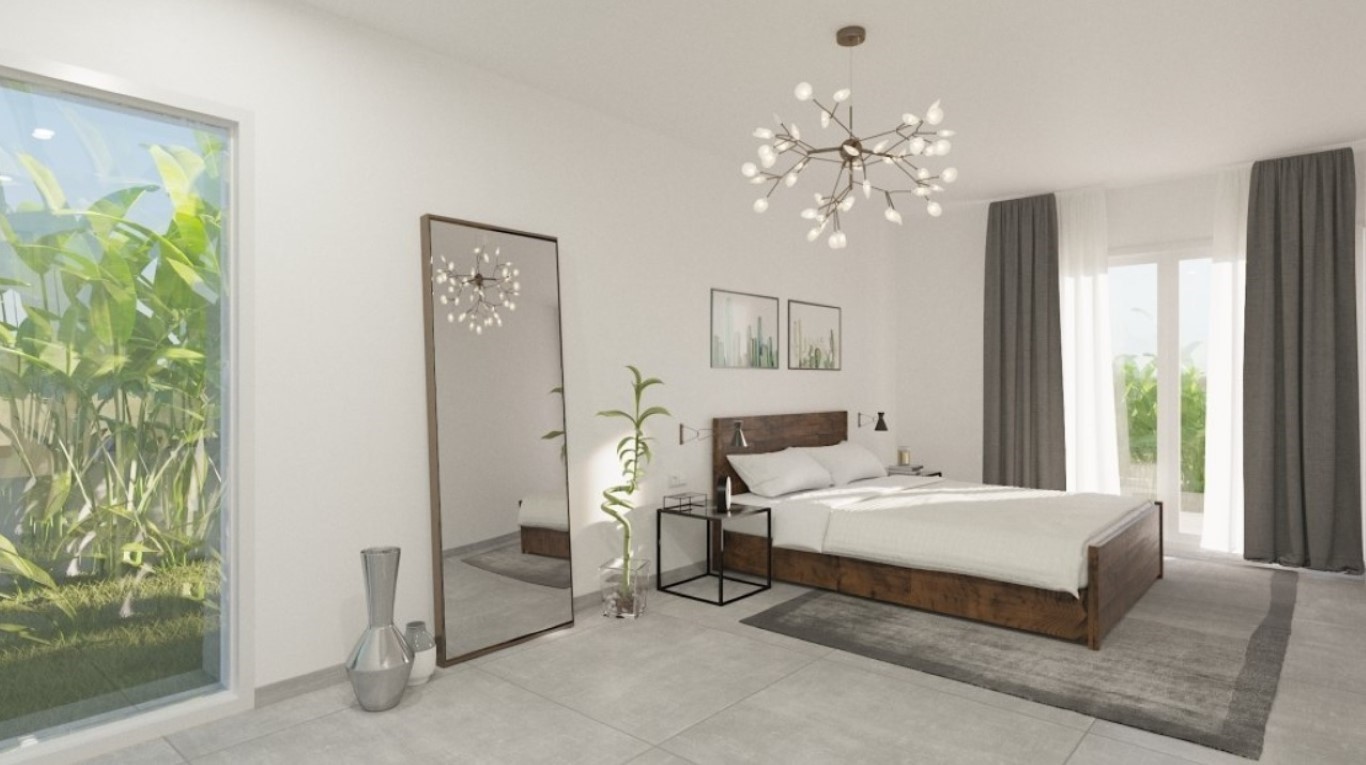 Master bedroom featuring a dark wood bed frame, a modern branch chandelier, and floor-to-ceiling windows overlooking lush Mediterranean greenery.