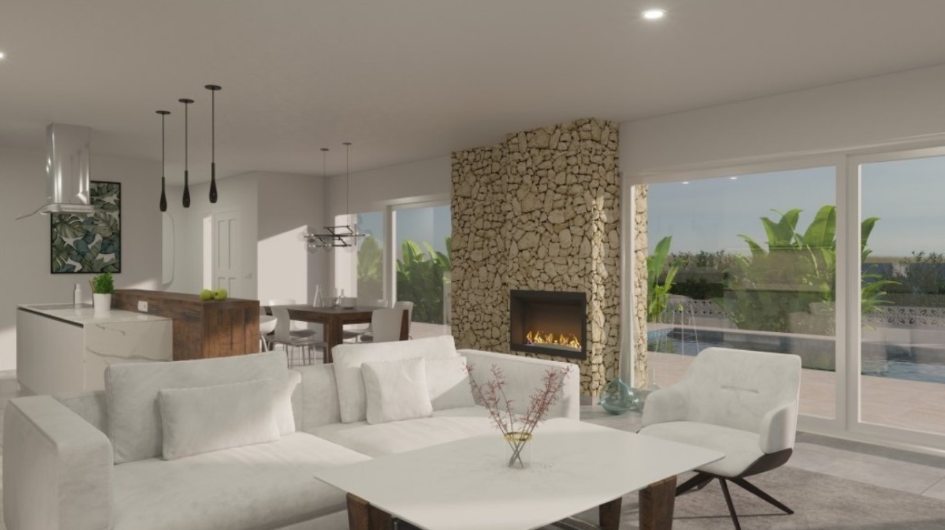 Open-plan living space featuring a natural stone fireplace wall, modern kitchen with wooden breakfast bar, and large glass doors opening to the pool terrace.