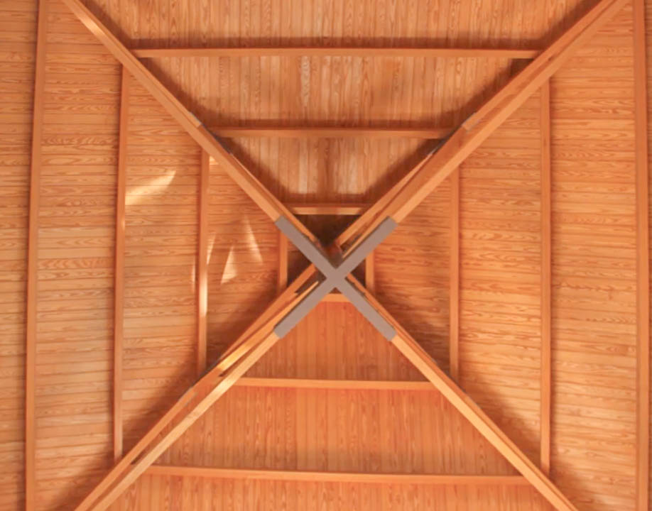 Detailed view of the high-quality vaulted wooden ceiling, featuring a symmetrical pyramidal structure with central cross-beam supports and natural grain finishes.