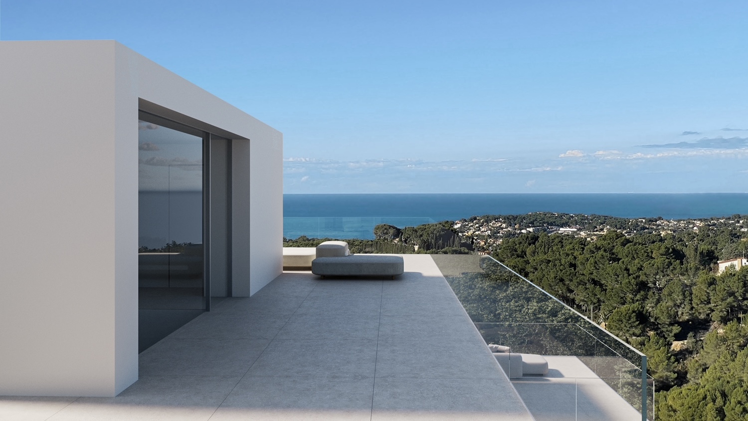 Upper terrace featuring large-format grey tiles, a frameless glass balustrade, and panoramic views over the Mediterranean coastline and pine forests.
