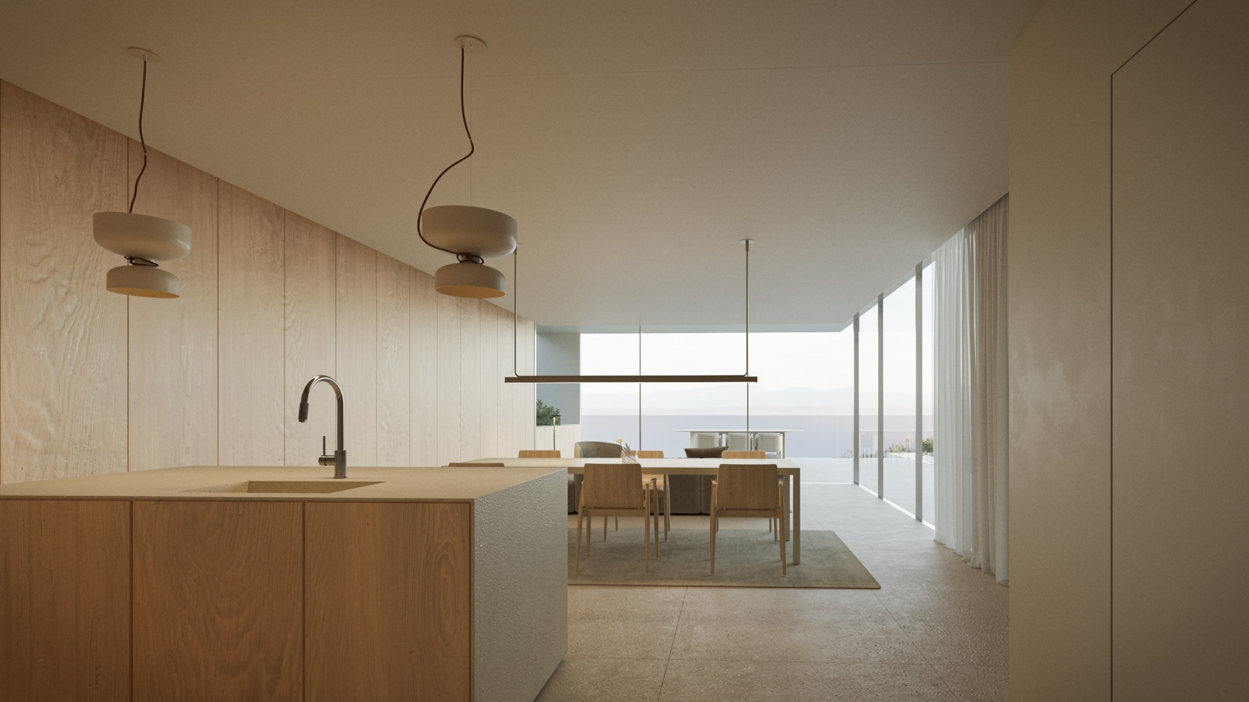 Modern open-plan kitchen featuring a wooden island, minimalist pendant lighting, and a dining area with panoramic coastal views through floor-to-ceiling glass.