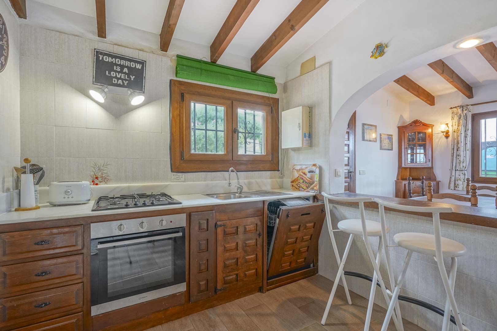 Rustic-style kitchen with dark wood cabinets and marble countertop.
