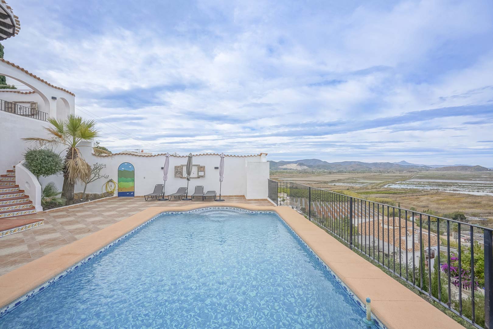 View of the private pool with blue tiles and terrace with panoramic views of the nature reserve.