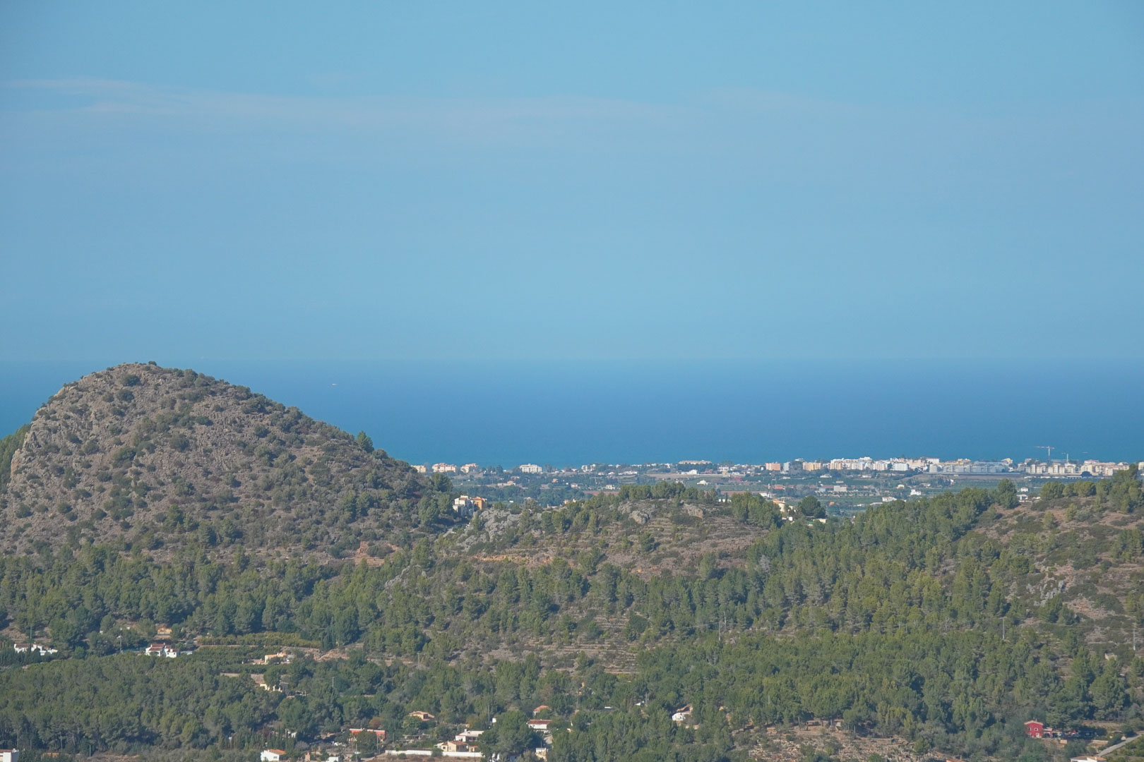 Panoramic views from the property featuring Mediterranean mountain ridges, scattered coastal settlements, and the blue horizon of the Mediterranean Sea.