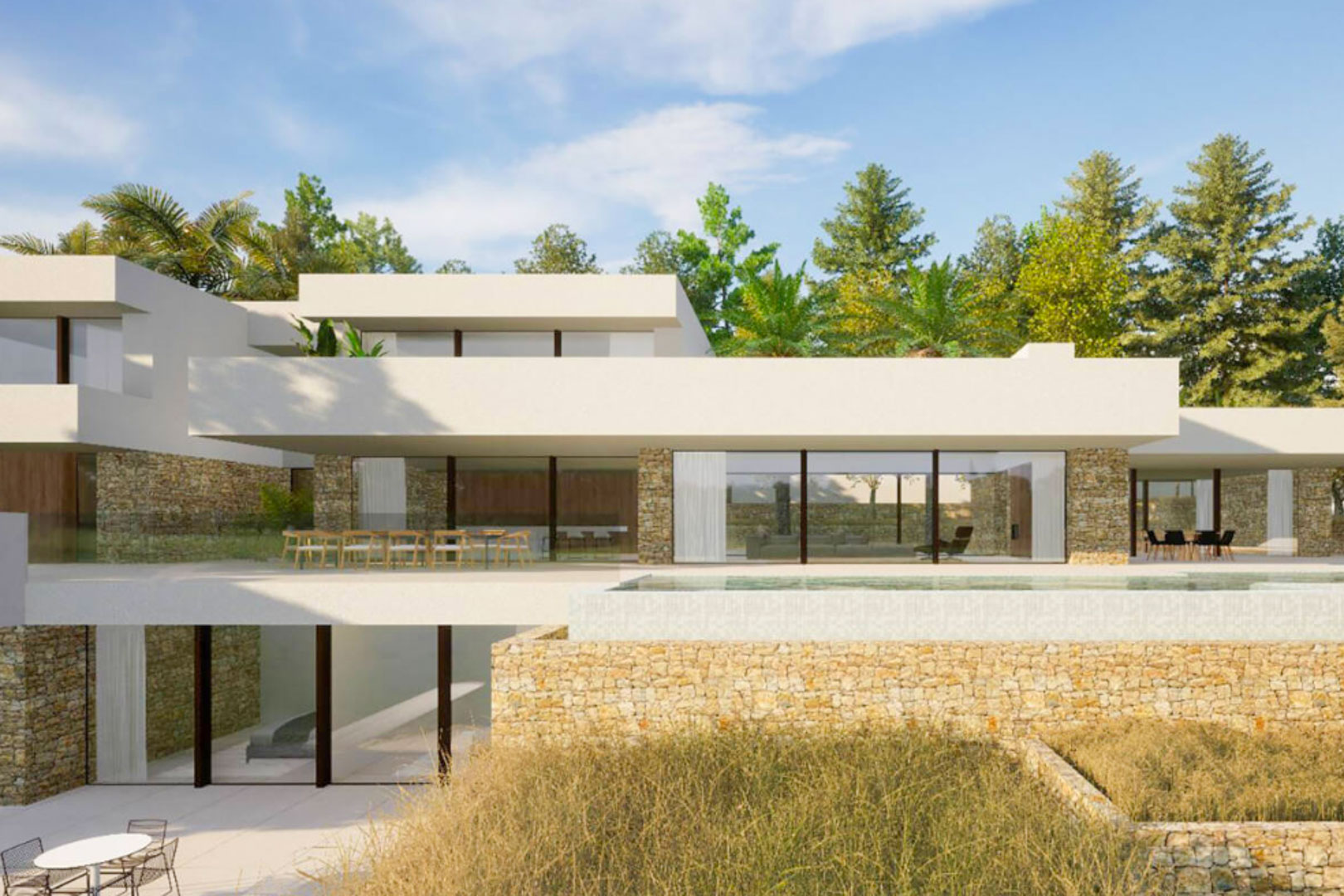 Modern three-level villa featuring natural stone walls, floor-to-ceiling glass facades, and an infinity pool integrated into the main terrace.