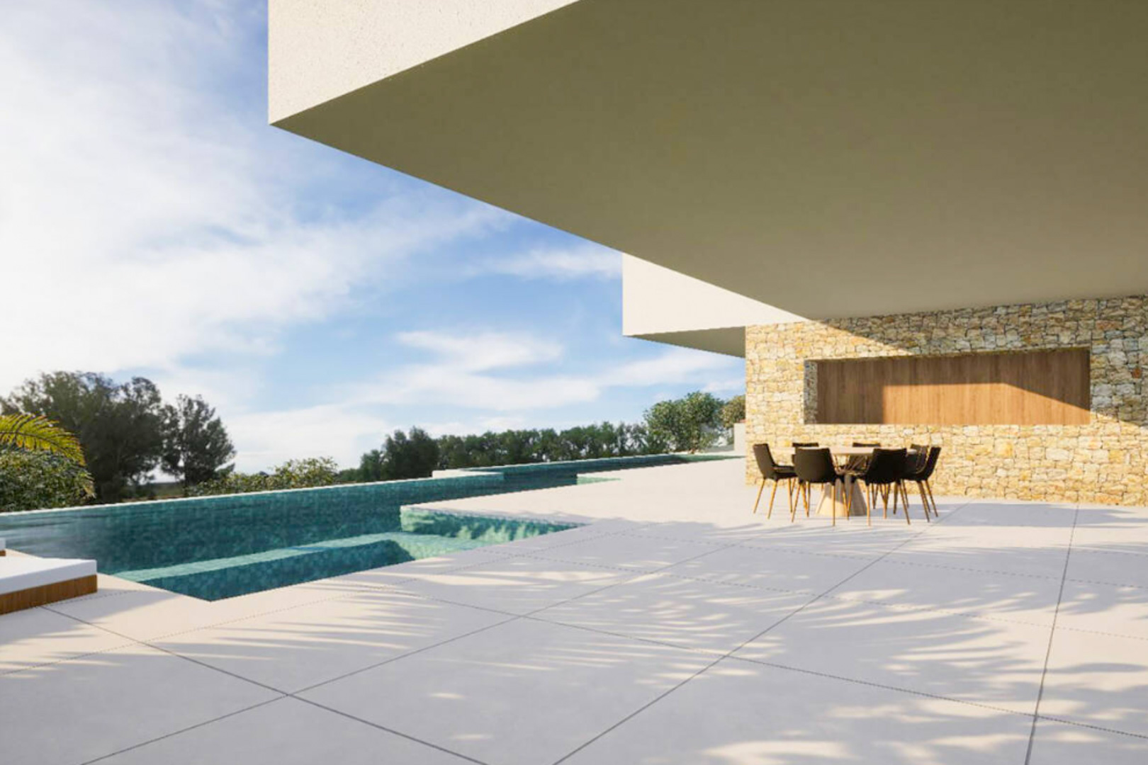 Outdoor terrace featuring large-format tiling, a cantilevered shaded dining area, and an infinity pool set against a natural stone wall with wood accents.