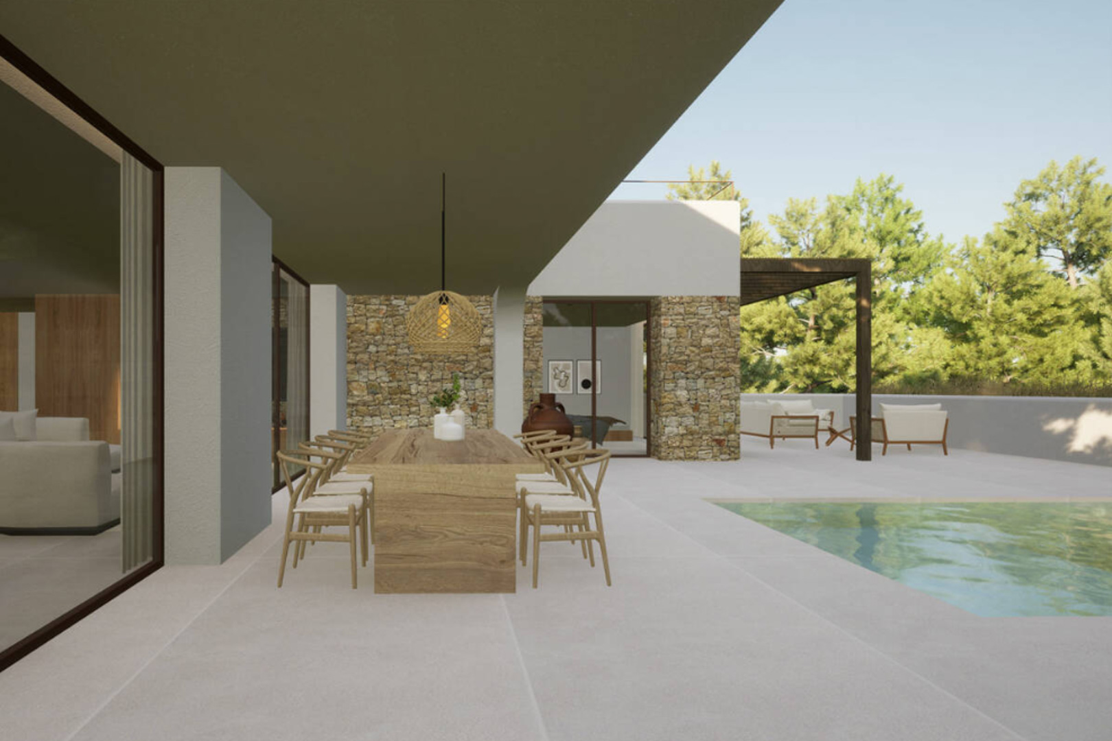 Covered outdoor dining area with solid wood table and rope chairs, next to the pool and natural stone wall.