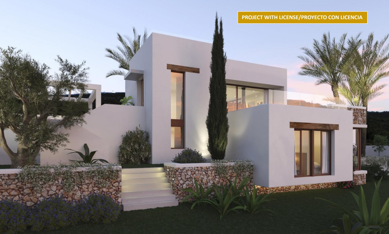 Ibizan-style exterior featuring natural stone walls, wooden lintels, and illuminated stairs connecting the modern white volumes with the Mediterranean garden.
