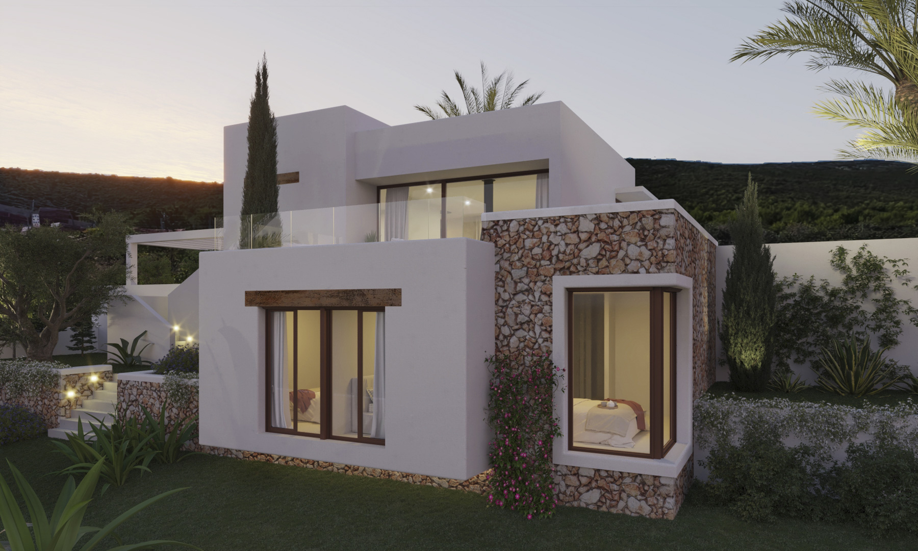 Ibizan-style exterior showcasing natural stone walls, white cubic architecture, and large windows integrated into a landscaped Mediterranean garden at dusk.