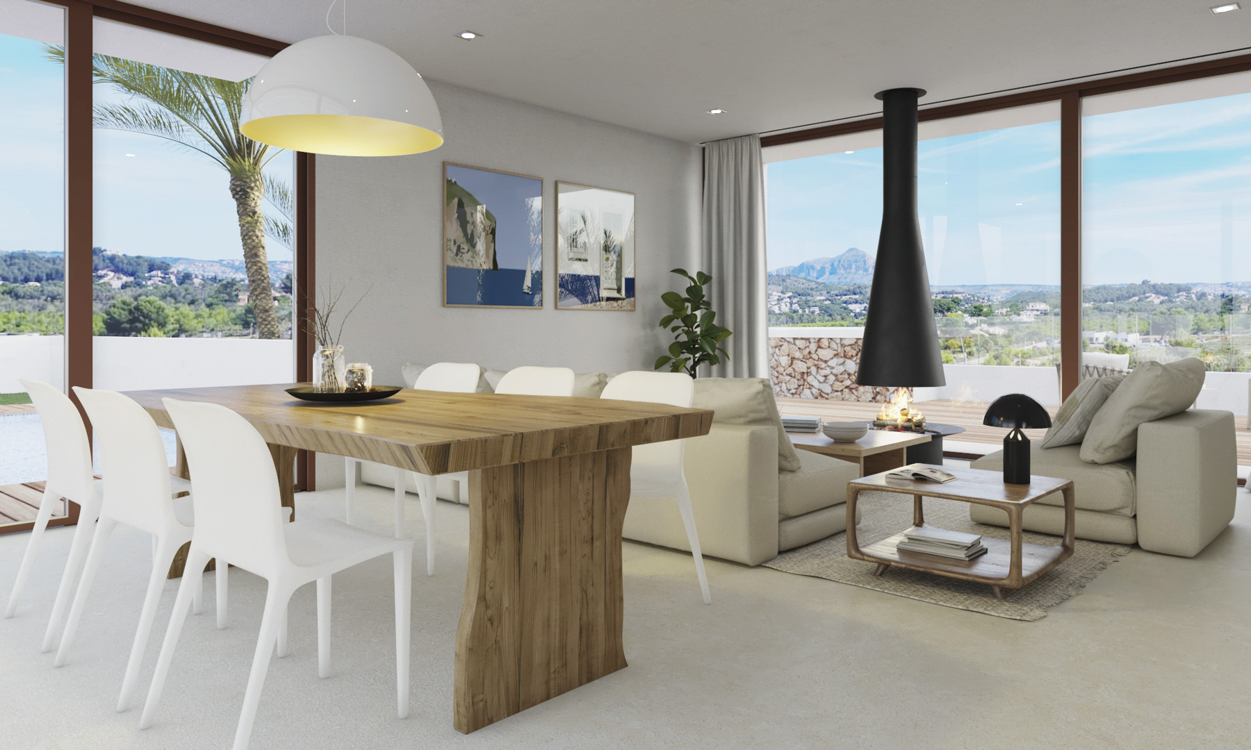 Open-plan living area featuring a solid wood dining table, a suspended black fireplace, and floor-to-ceiling windows overlooking the Montgó mountain.