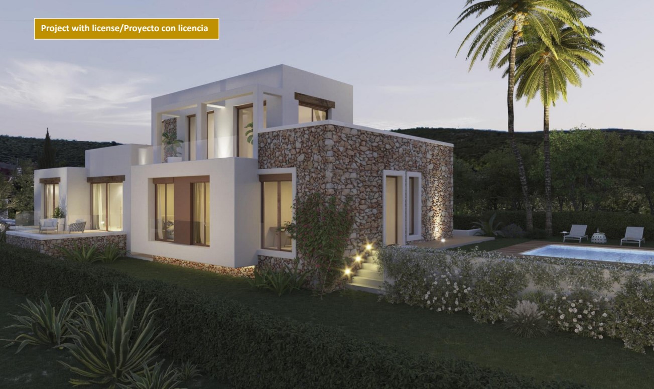 Exterior view of the villa featuring natural stone walls, white facades, an illuminated swimming pool, and upper-level terraces with glass railings.