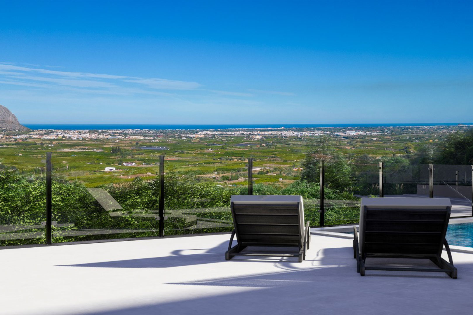 Elevated terrace featuring glass railings and contemporary sun loungers, offering panoramic views of the valley and the Mediterranean coastline.