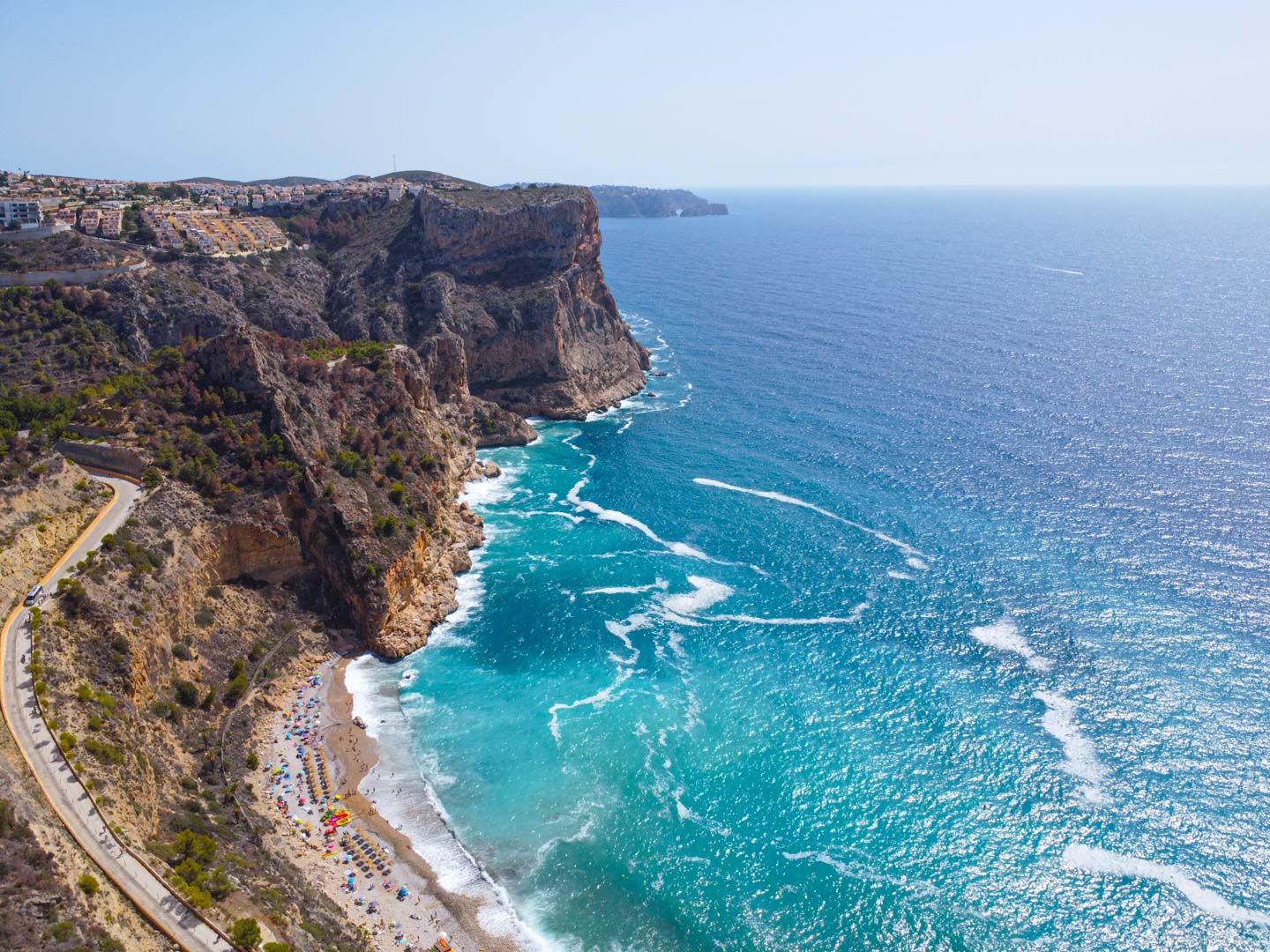 Aerial view of the Cumbre del Sol cliffs and Mediterranean coastline, featuring turquoise waters and the rugged natural landscape near the property.