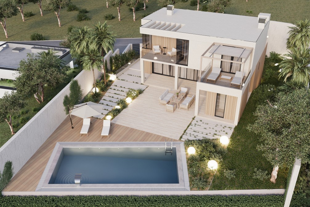 Aerial view of the villa featuring a rectangular pool, wood deck, and illuminated garden.