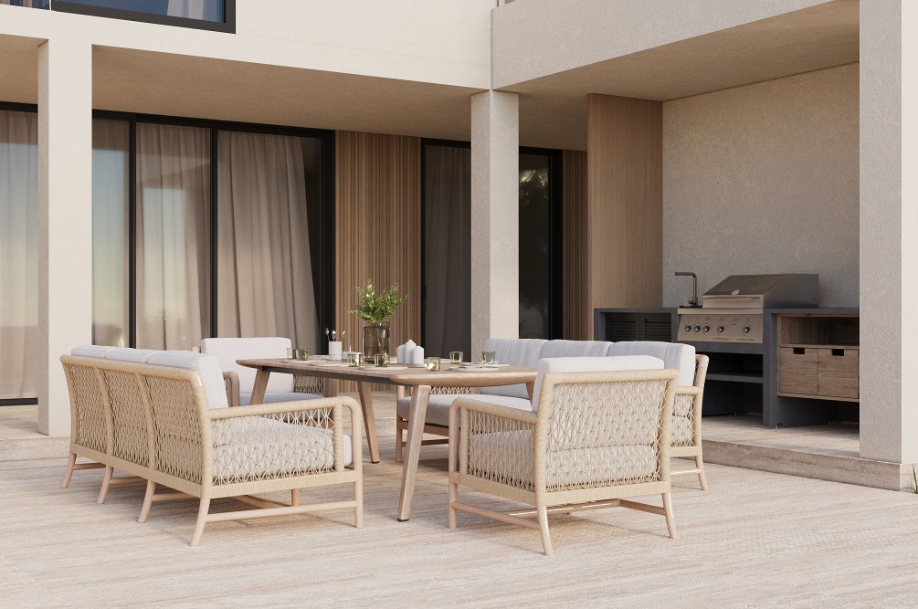 Covered outdoor dining area with rattan furniture and an outdoor kitchen with a grill.
