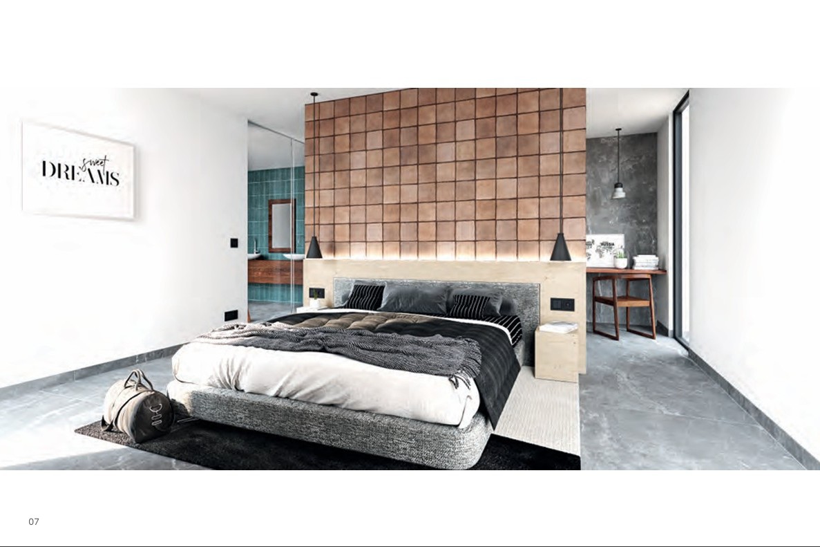 Master bedroom featuring a terracotta tile accent wall, wooden headboard with integrated lighting, and an en-suite bathroom with teal tiles behind glass.