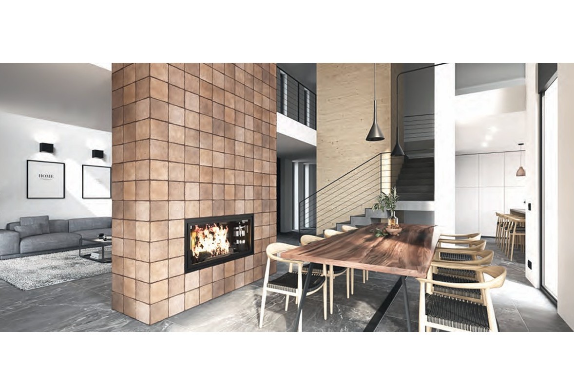 Open-plan living and dining area featuring a central fireplace wall with terracotta tiles, a live-edge wooden table, and a modern staircase with metal railings.