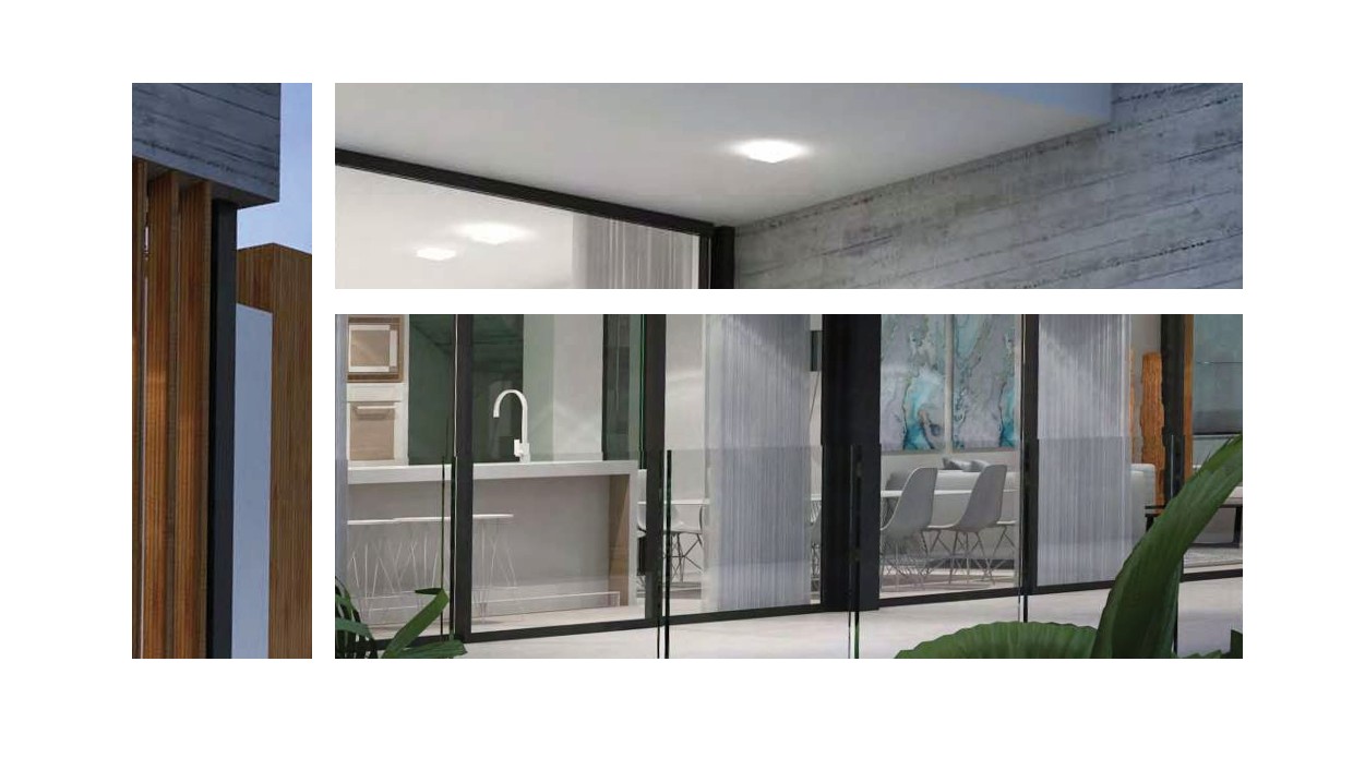 Exterior view of the ground floor showcasing the modern kitchen with a white island and dining area through floor-to-ceiling glass doors and glass railings.