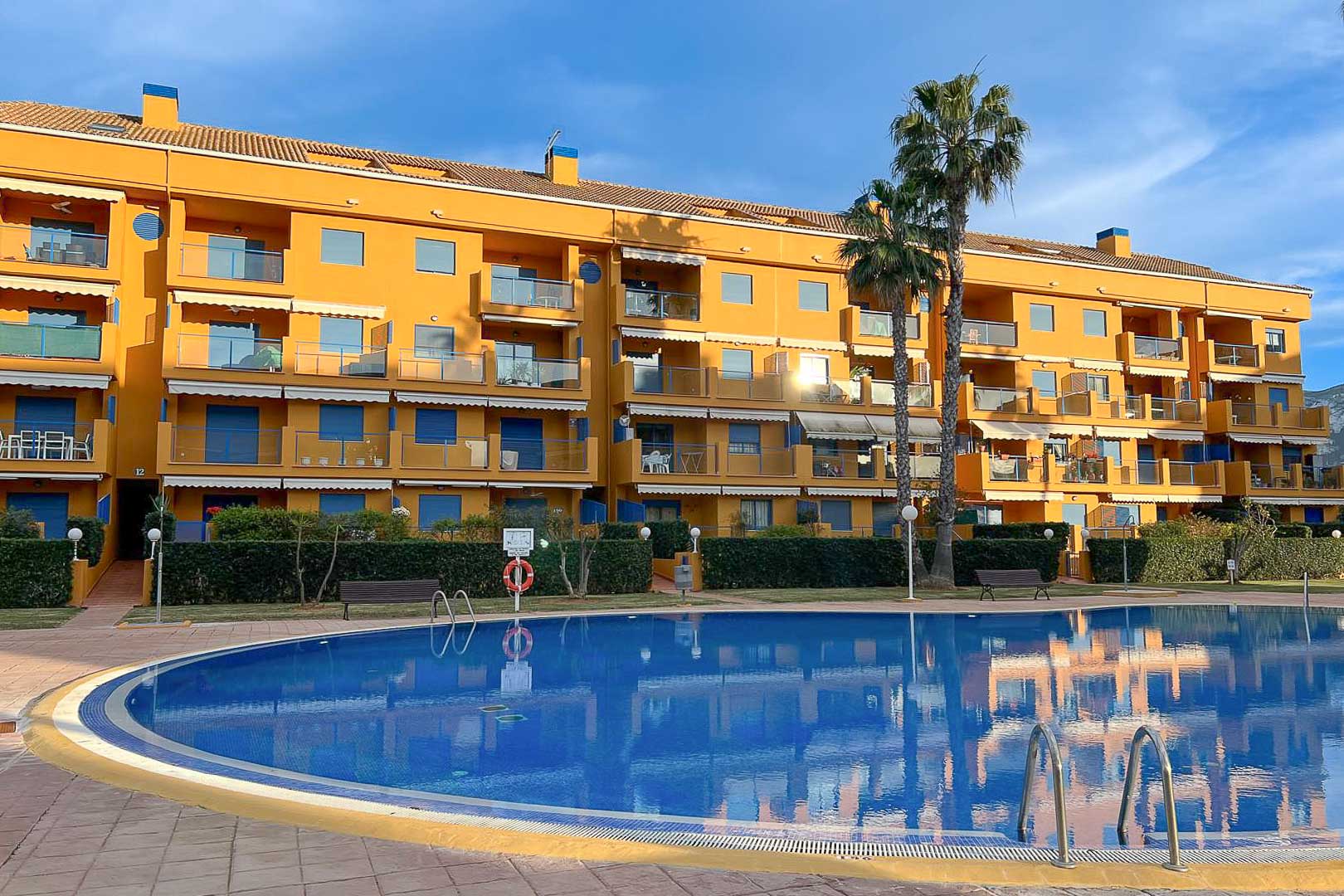 Exterior view of the community pool and facade of the residential building in Dénia.