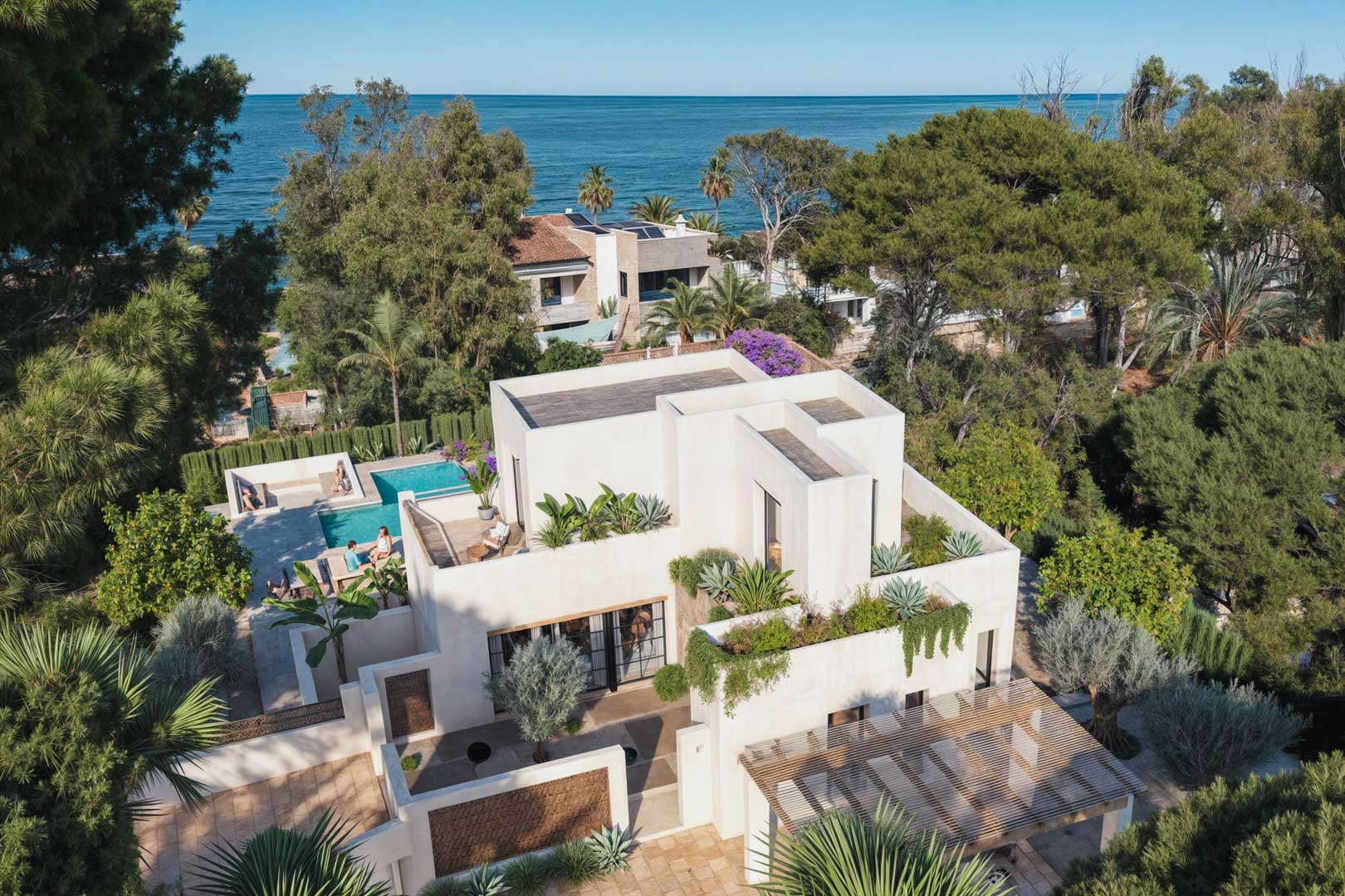 Aerial view of modern villa with rooftop greenery and pool, near the sea in Dénia.