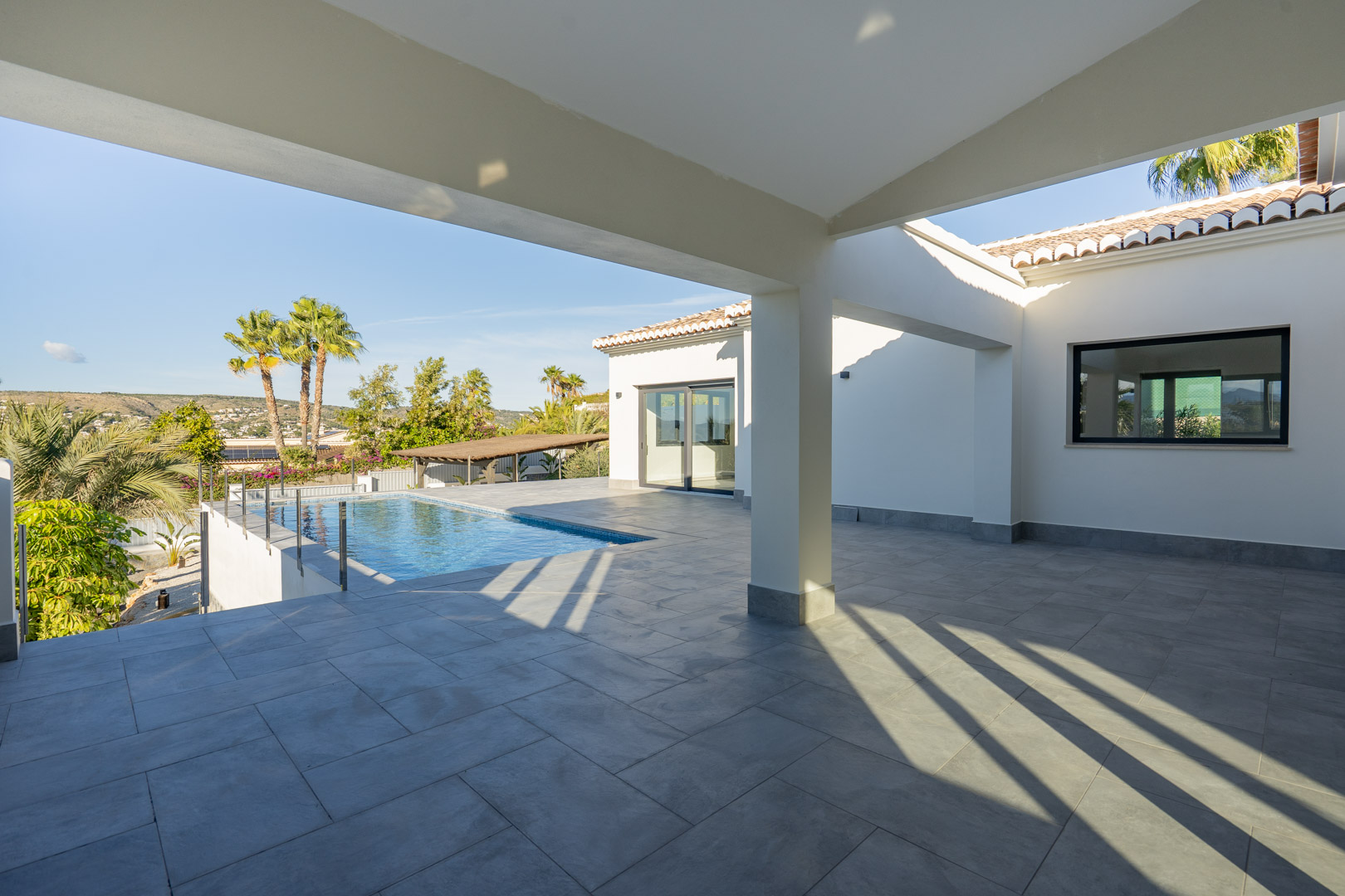 Covered terrace featuring a pool and panoramic views in Jávea.