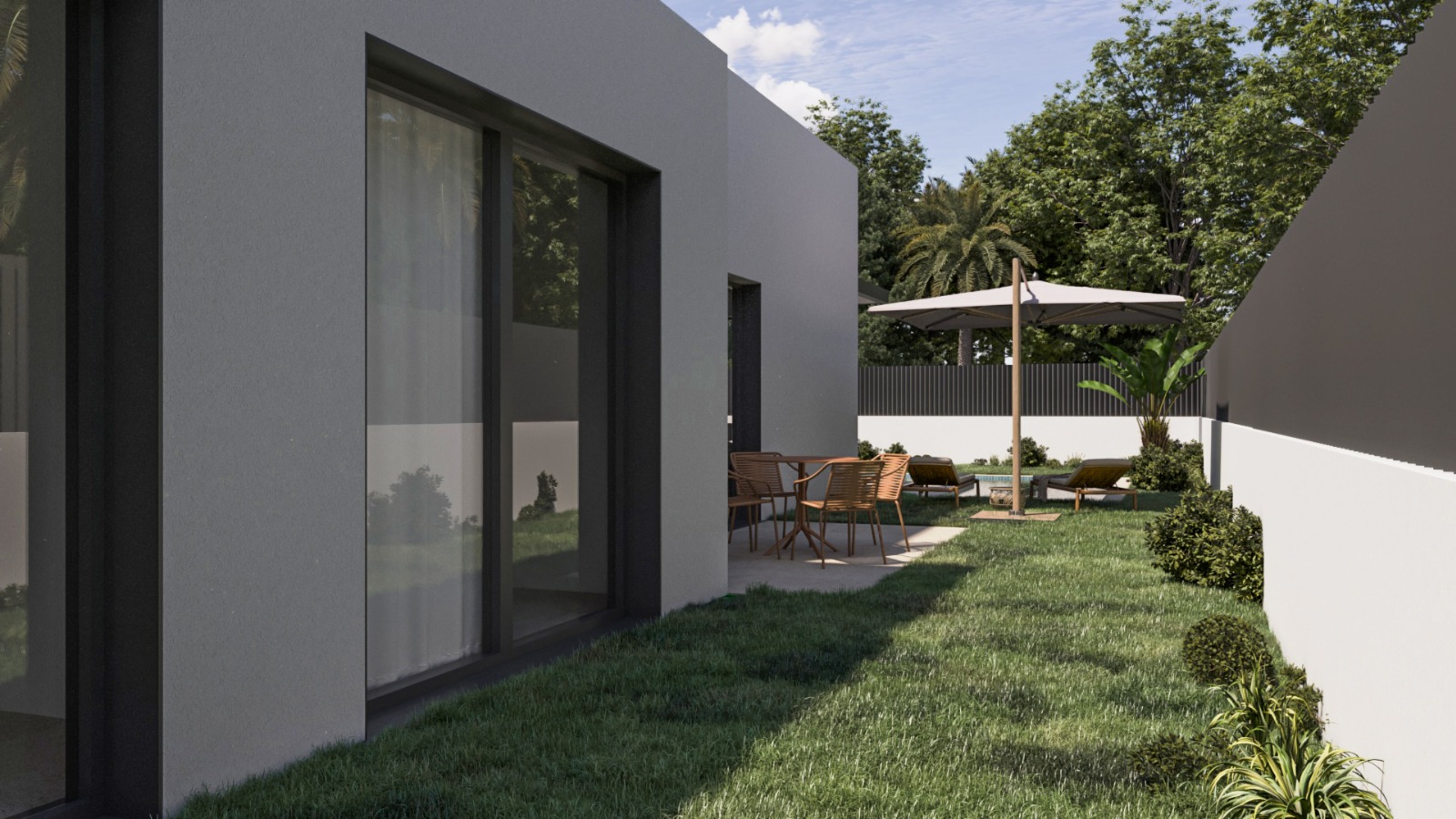 Villa exterior featuring minimalist gray facades, large glass doors, and a private garden with a paved dining terrace and sun loungers under a parasol.