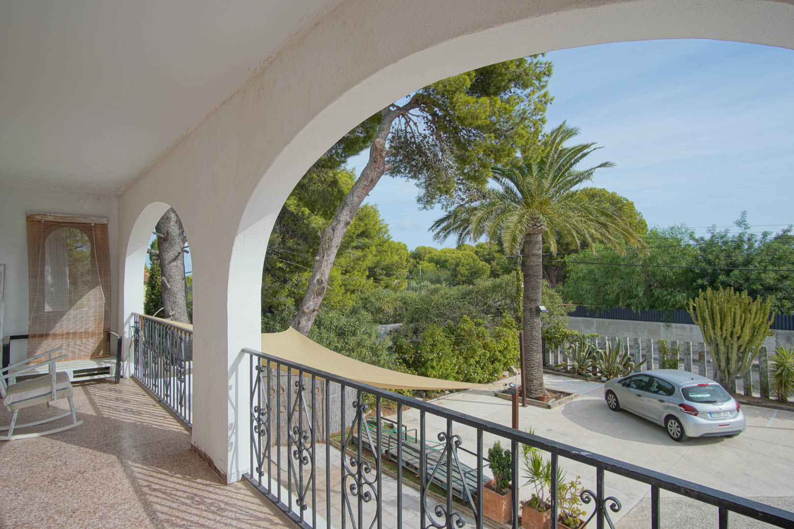 Covered balcony with garden views